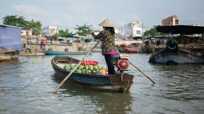 Femme sur une barque avec des pastèques