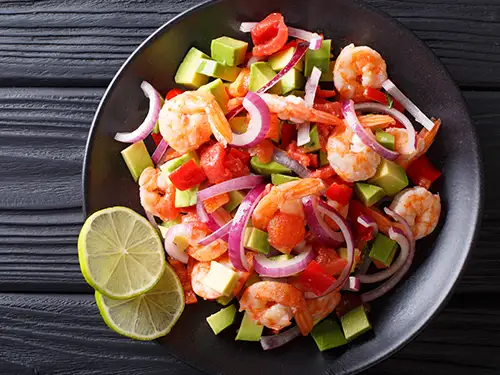 Assiette avec avocat, crevettes et poivrons
